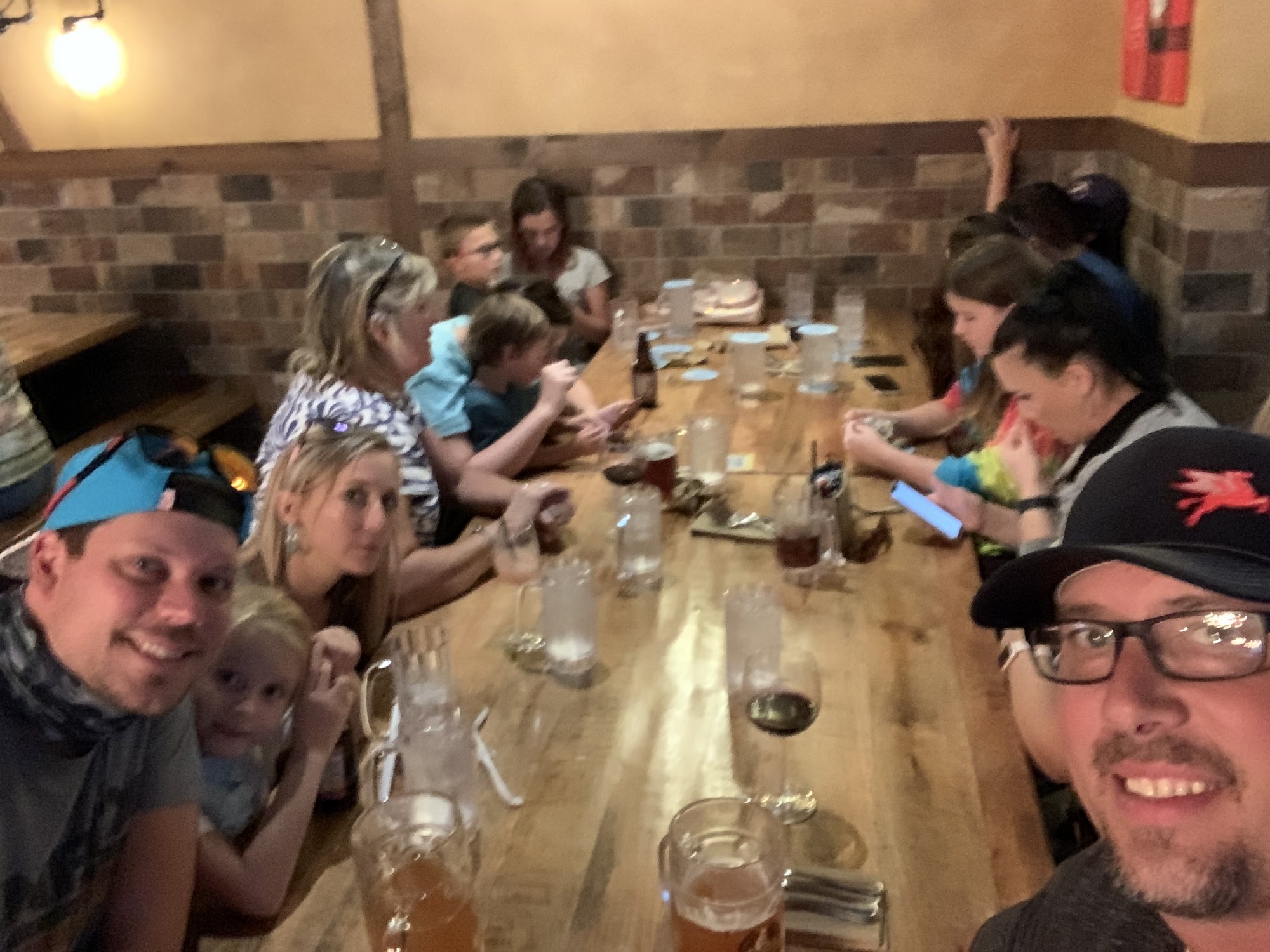 A group of friends gathered around a long dinner table